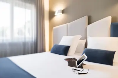 a hotel room with a bed with a laptop on it at Hotel Boa Vista in Viveiro