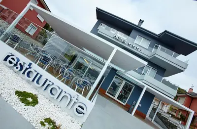a building with a sign in front of it at Hotel Boa Vista in Viveiro