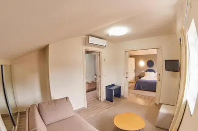 a living room with a couch and a bed at Hotel Boa Vista in Viveiro