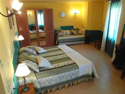 a living room with a bed and a couch at La Casa del Filandón- HOTEL RURAL in Quintanilla de Somoza