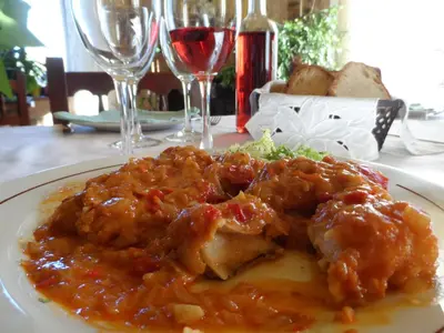 a plate of food on a table with wine glasses at La Casa del Filandón- HOTEL RURAL in Quintanilla de Somoza