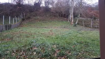 a grassy field with a fence and trees at Casa Páez in Pasantes