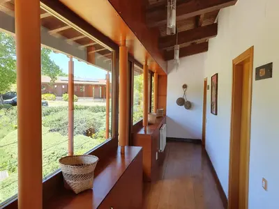 a hallway with a large window in a house at Rectoral De Lestedo in Palas de Rei