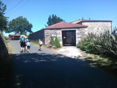 a group of people walking down a road at Rectoral De Lestedo in Palas de Rei