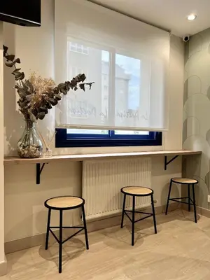 a kitchen with two stools and a counter with a window at Hostal LA POETISA - Auto Check-in in Culleredo