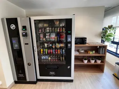 a vending machine filled with lots of drinks at Hostal LA POETISA - Auto Check-in in Culleredo