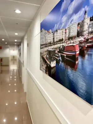 a painting of a harbor on a wall in a hallway at Hostal LA POETISA - Auto Check-in in Culleredo