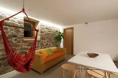 a room with a couch and a hammock at Outeiro de Setecamiños in Cuntis