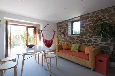a living room with a couch and a table at Outeiro de Setecamiños in Cuntis