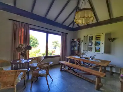 a dining room with a table and chairs and a window at Apartamentos La Cruz de Paderne in Navia