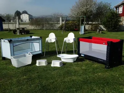 a tv and a toilet and a television on the grass at Apartamentos La Cruz de Paderne in Navia
