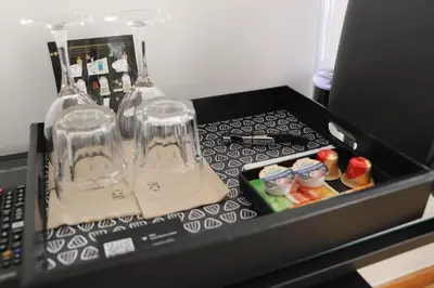 a black box with two glass bottles on top of a microwave at Stellae Luscofusco in Santiago de Compostela
