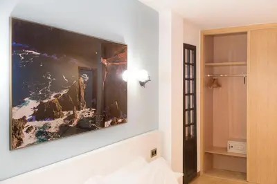 a large flat screen tv on a wall in a room at Stellae Luscofusco in Santiago de Compostela