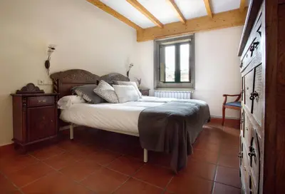 a bedroom with a bed and a window at Casa do Cruceiro in As Galanas