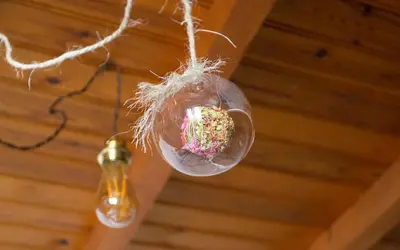a cupcake in a glass ball hanging from a ceiling at Casa do Cruceiro in As Galanas