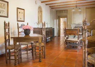 a living room with a table and chairs and a couch at Casa do Cruceiro in As Galanas