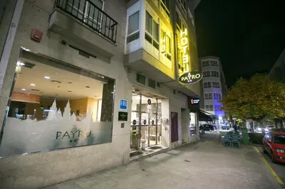 a store with a sign on the side of a building at Hotel PAYRO in Santiago de Compostela