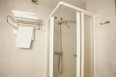 a bathroom with a shower with a glass door at Hotel PAYRO in Santiago de Compostela