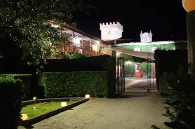 a gate to a house with a castle at night at Casa Grande de Rosende in Sober