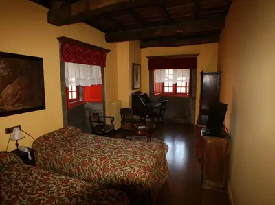 a bedroom with a bed and a living room at Casa Grande de Rosende in Sober