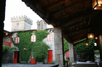 a building with green ivy on the side of it at Casa Grande de Rosende in Sober