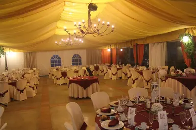 a banquet hall with tables and chairs and a chandelier at Casa Grande de Rosende in Sober