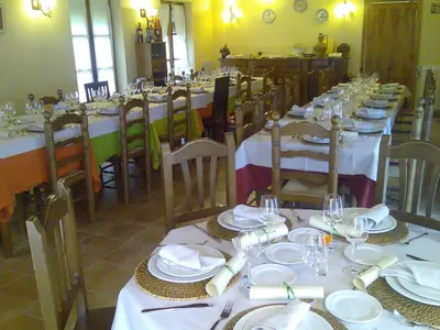 a dining room with tables with white plates and glasses at Hotel Rural Aguallevada in Paramio