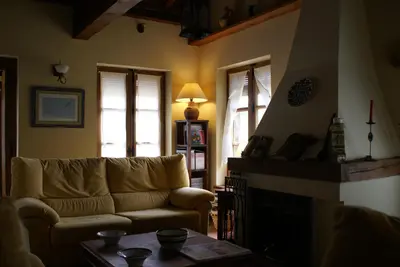 a living room with a couch and a fireplace at Hotel Rural Aguallevada in Paramio