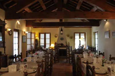 a dining room with tables and chairs in a building at Hotel Rural Aguallevada in Paramio