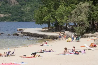 a group of people laying on a beach at Hospedería El Pico del Fraile in Cobreros