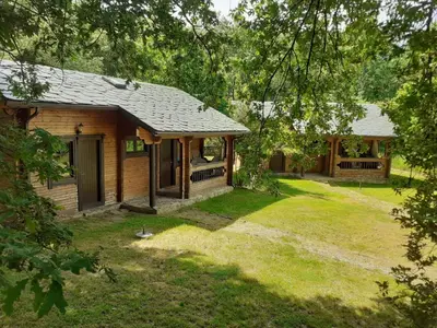 a log cabin with a yard and a house at La Albarina in Galende