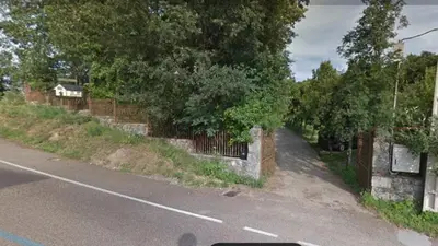 a road with a fence on the side of a street at La Albarina in Galende