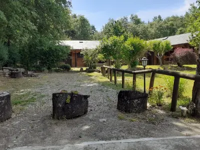 a garden with trees and a wooden fence at La Albarina in Galende