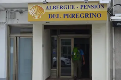 a man is standing outside of a building at Albergue del Peregrino in Arzúa