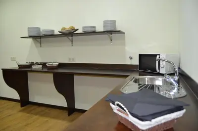 a kitchen with a sink and a counter with plates at Albergue del Peregrino in Arzúa