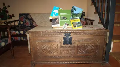 an old wooden cabinet with items on top of it at La Artesana in Posada de Rengos