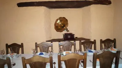 a dining room with a table with chairs and a table at La Artesana in Posada de Rengos