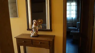 a bathroom with a table with a mirror and a sink at La Artesana in Posada de Rengos