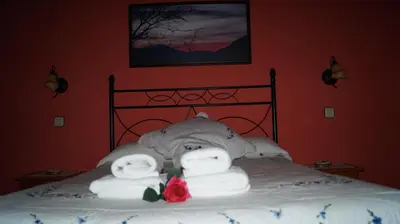 a bed with two rolls of towels on it at La Artesana in Posada de Rengos