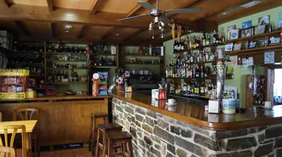 a bar in a restaurant with a brick wall at La Artesana in Posada de Rengos