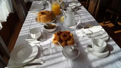 a table with a white table cloth with food on it at La Artesana in Posada de Rengos