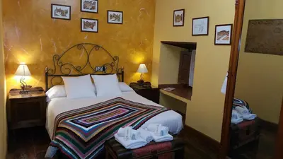 a hotel room with a bed with shoes on it at VV La Pumarada De Limés II in Cangas del Narcea