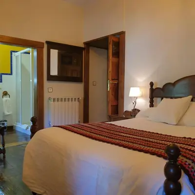 a bedroom with a large bed in a room at VV La Pumarada De Limés II in Cangas del Narcea