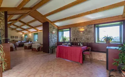 a restaurant with a red table in a room at Pazo de Sedor in Arzúa