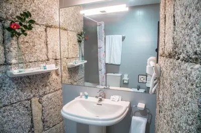 a bathroom with a sink and a mirror at Pazo de Sedor in Arzúa