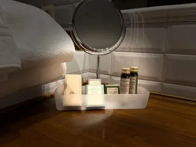 a tray of products sitting on the floor next to a mirror at Rectoral de Cines in Oza dos Ríos