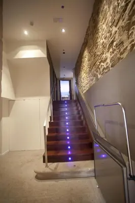 a staircase in a building with purple lights at Carris Casa de la Troya in Santiago de Compostela