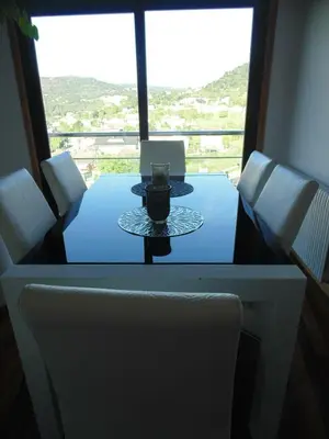 a table and chairs with a view of a window at Duplex grandes cristaleras impresionantes vistas in Ourense