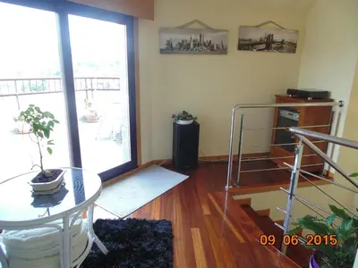 a living room with a glass table and a window at Duplex grandes cristaleras impresionantes vistas in Ourense