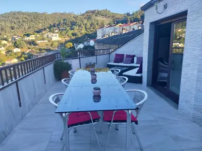 a blue table on a balcony with a view at Duplex grandes cristaleras impresionantes vistas in Ourense